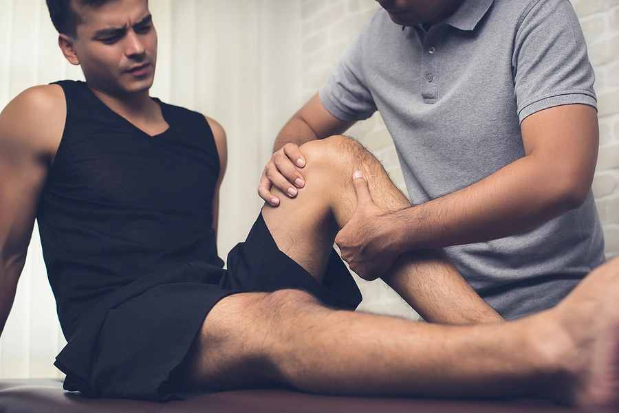 Man getting physical therapy for his knee as a consequences of a slip and fall injury