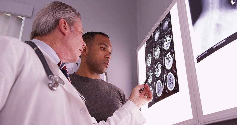 Patient with a traumatic brain injury from a Minnesota accident listens as his doctor explains his scans